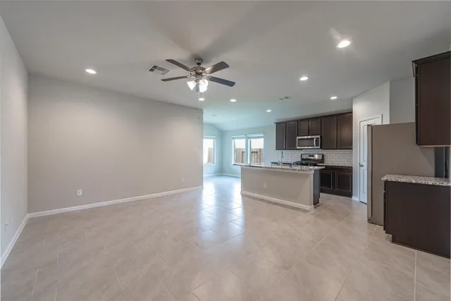 a view of kitchen with refrigerator and microwave