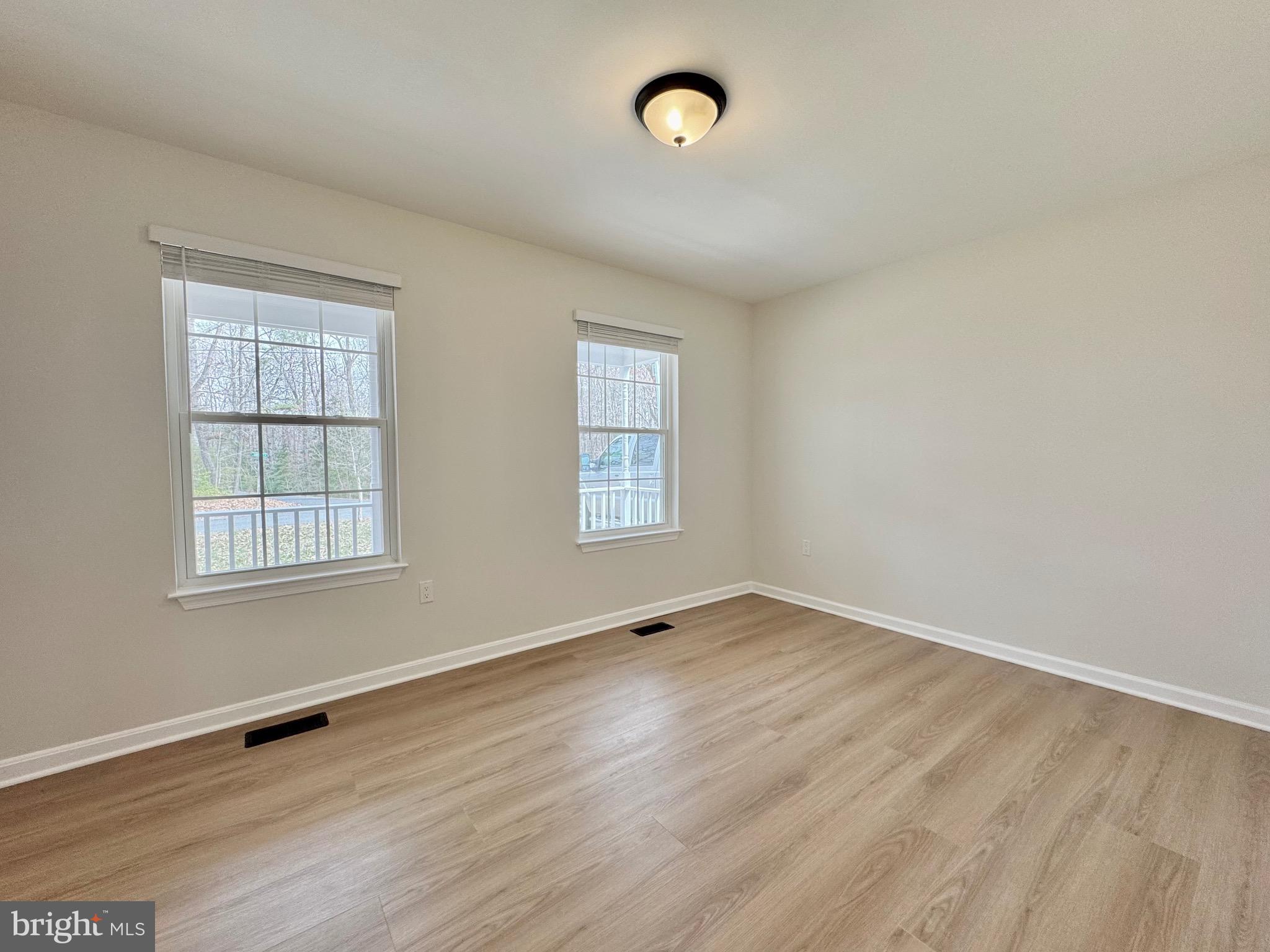 640 Santa Fe Trail Lusby, MD 20657 - Photo 13 of 26 an empty room with wooden floor and windows