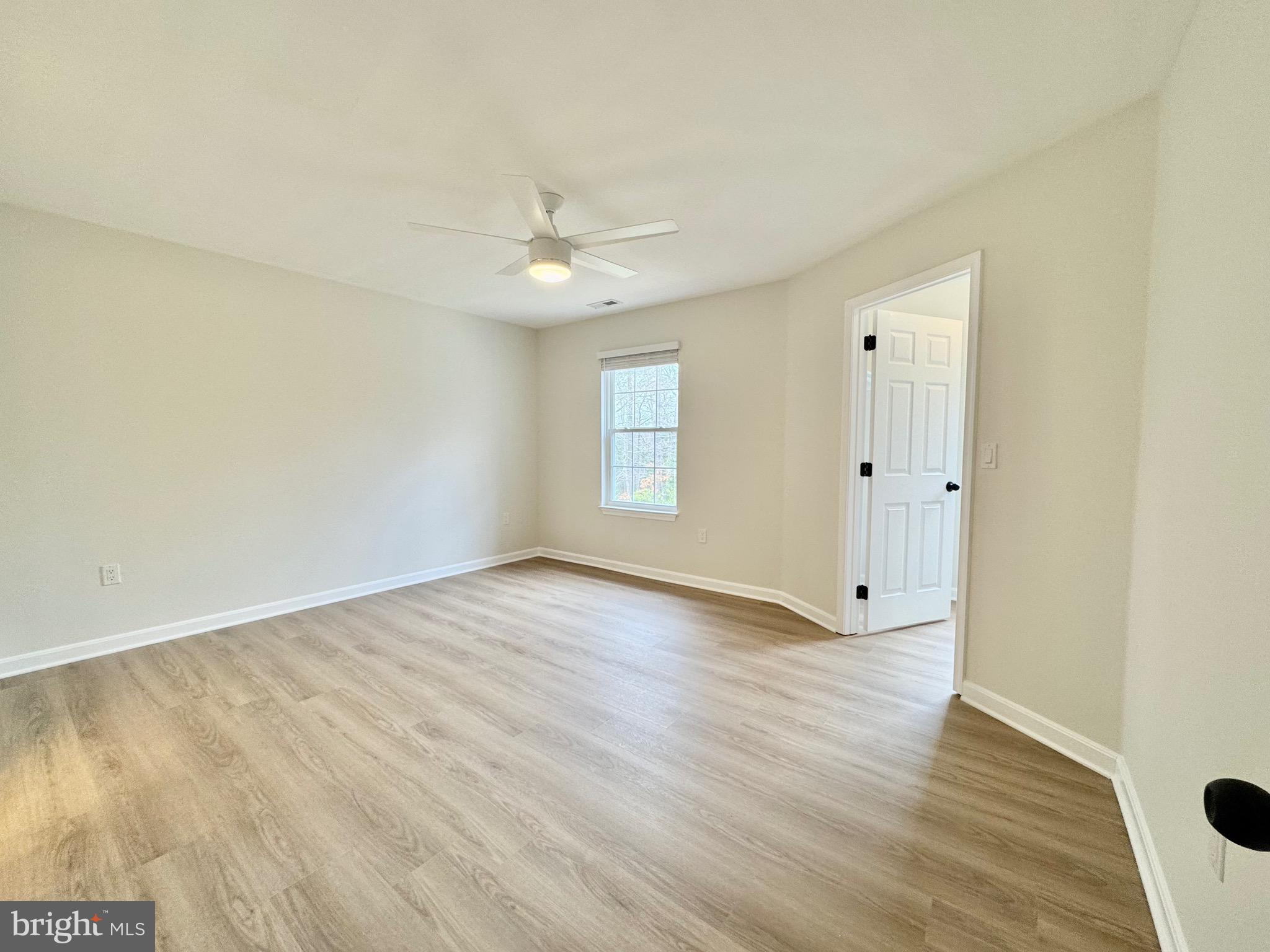 640 Santa Fe Trail Lusby, MD 20657 - Photo 15 of 26 an empty room with wooden floor and windows