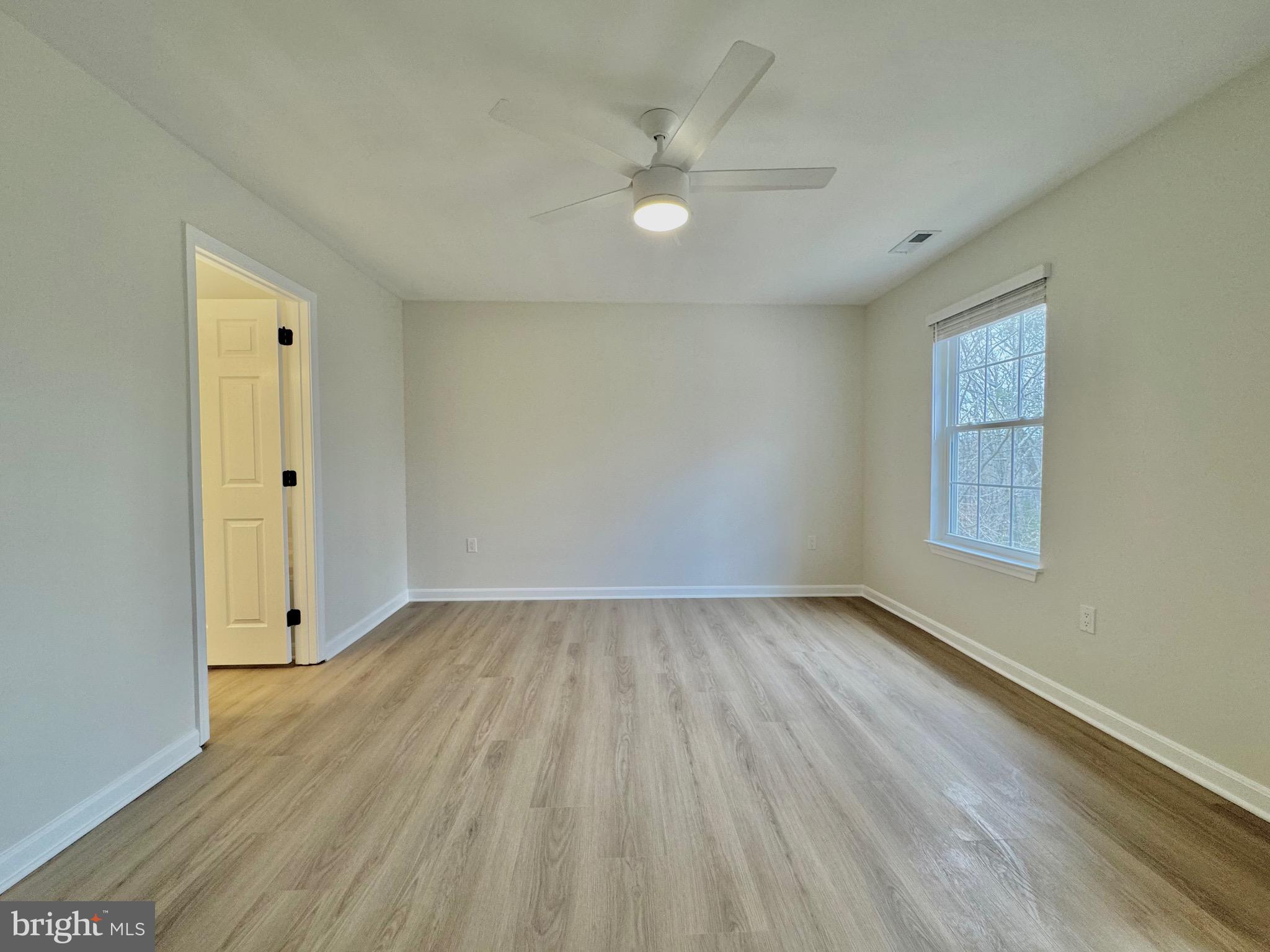 640 Santa Fe Trail Lusby, MD 20657 - Photo 16 of 26 an empty room with wooden floor and windows