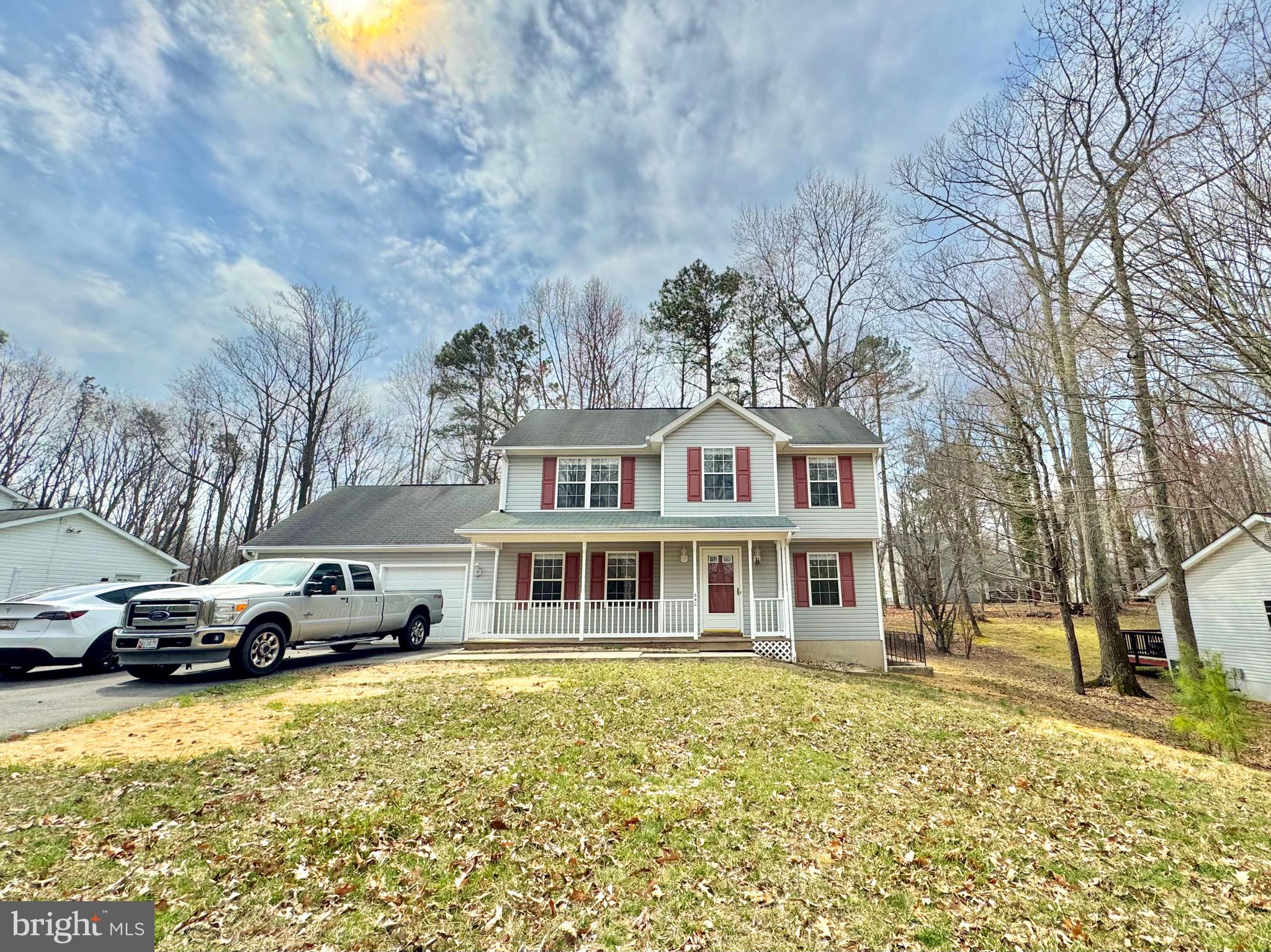 640 Santa Fe Trail Lusby, MD 20657 - Photo 2 of 26 a front view of a building with lot of cars and trees