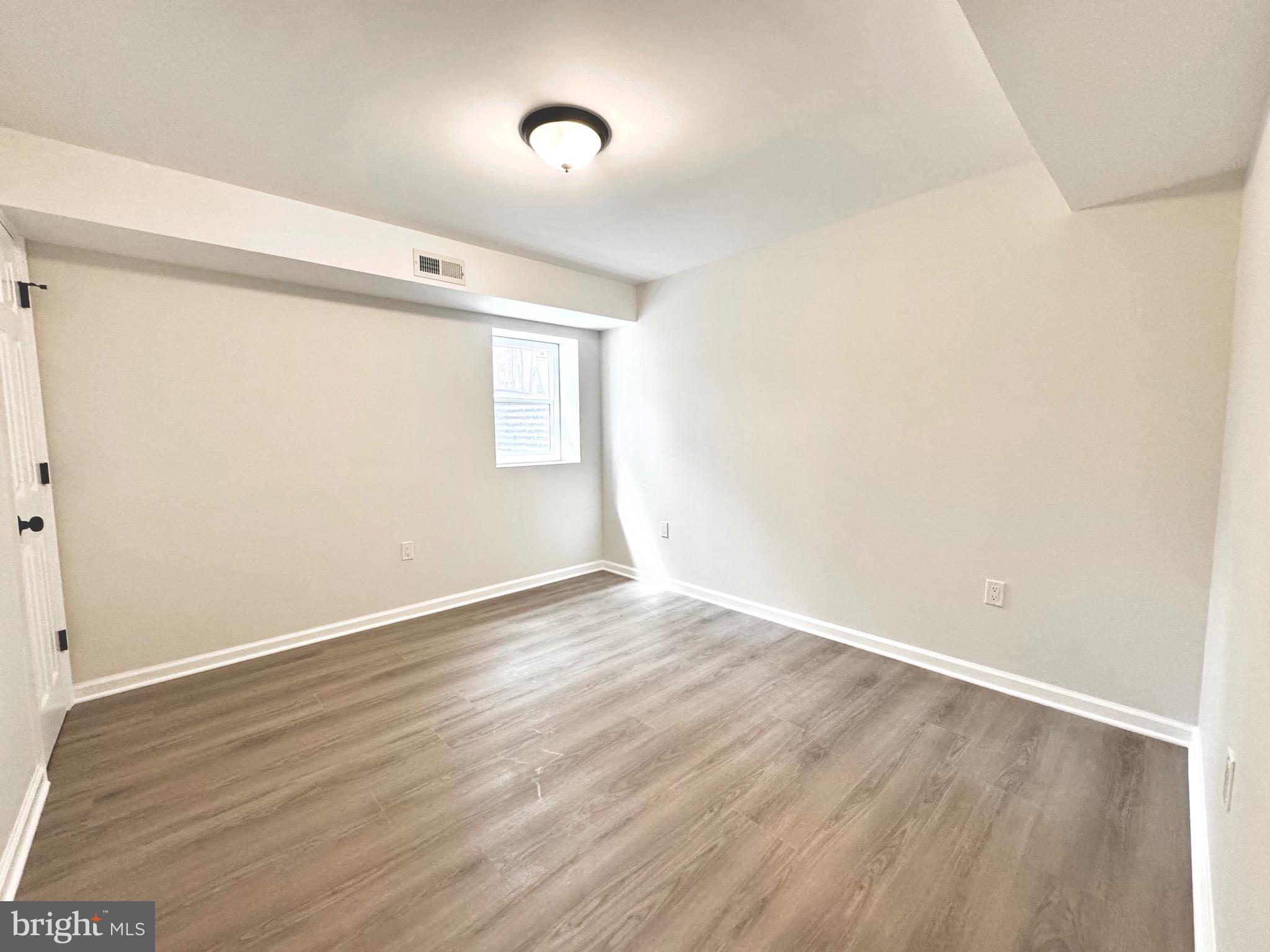 640 Santa Fe Trail Lusby, MD 20657 - Photo 26 of 26 a view of an empty room with wooden floor and a window