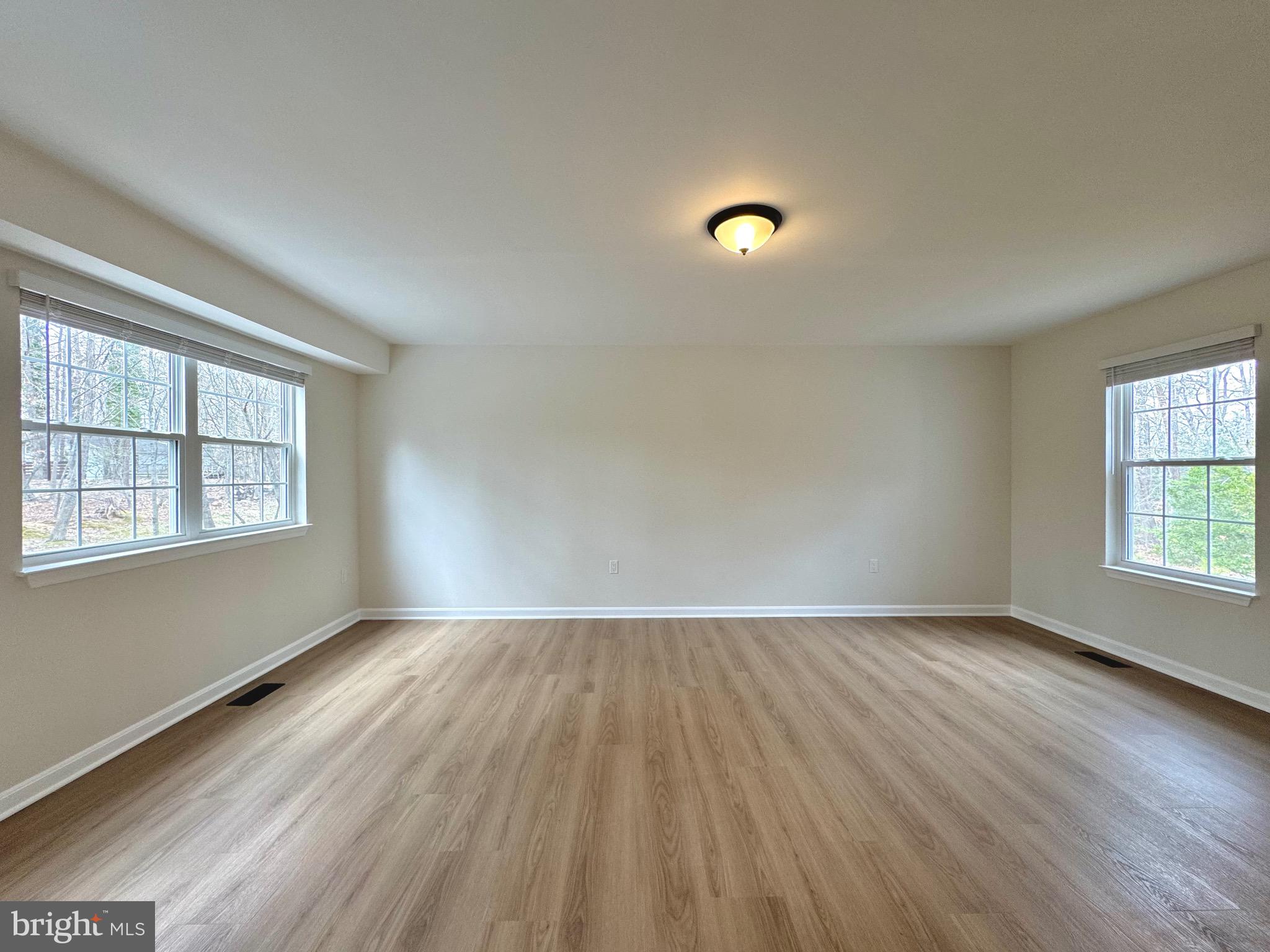 640 Santa Fe Trail Lusby, MD 20657 - Photo 4 of 26 an empty room with wooden floor and windows