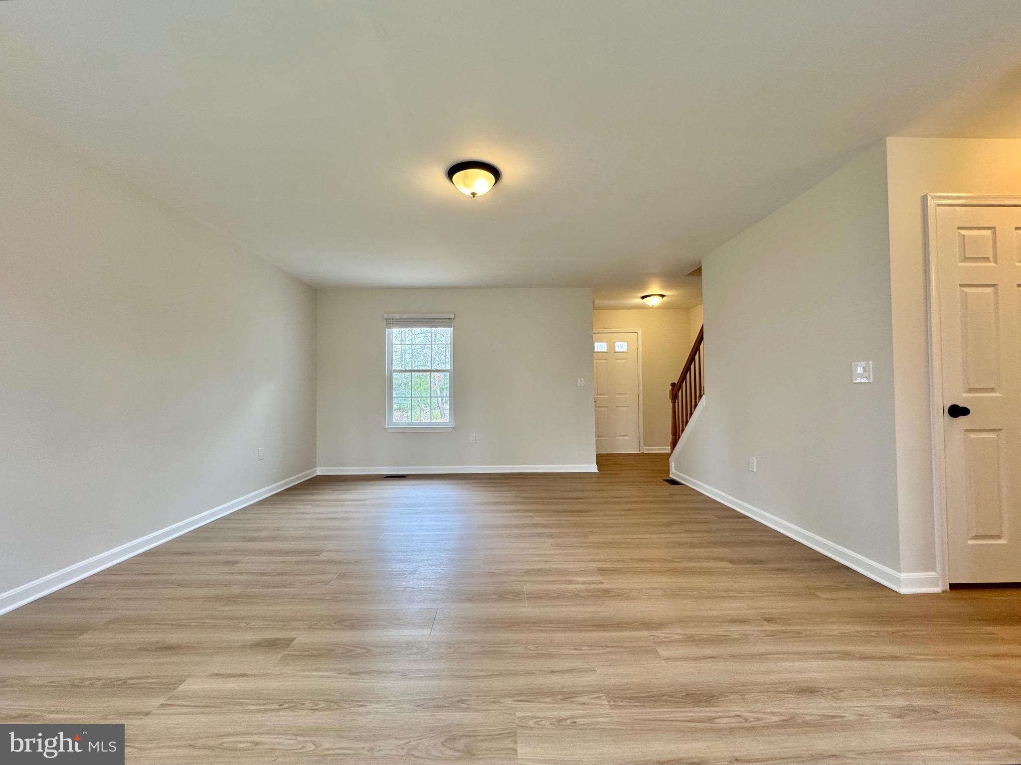 640 Santa Fe Trail Lusby, MD 20657 - Photo 5 of 26 a view of an empty room with wooden floor and a window