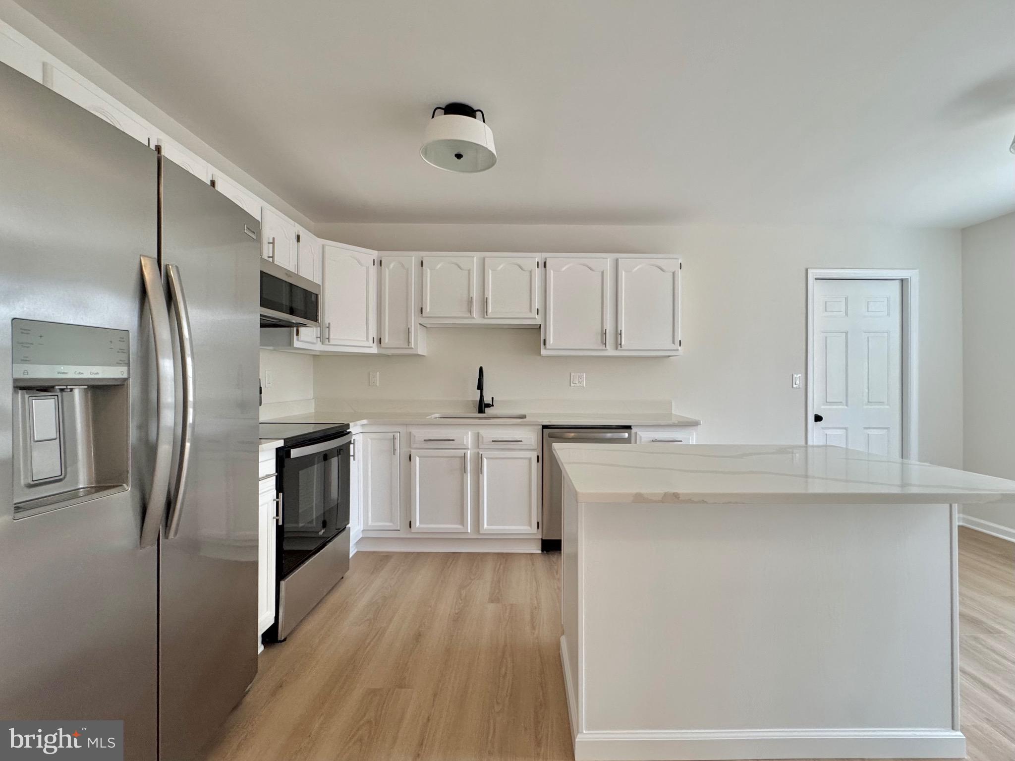640 Santa Fe Trail Lusby, MD 20657 - Photo 8 of 26 a kitchen with stainless steel appliances granite countertop a stove a sink and a refrigerator
