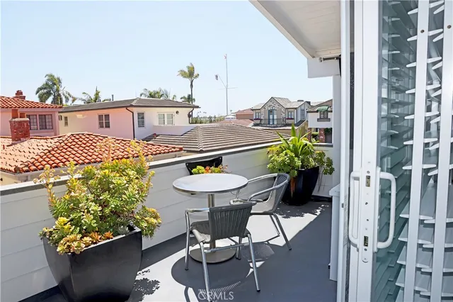 a balcony with table and chairs