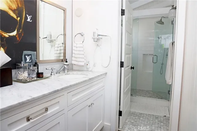 a bathroom with a granite countertop sink and a mirror