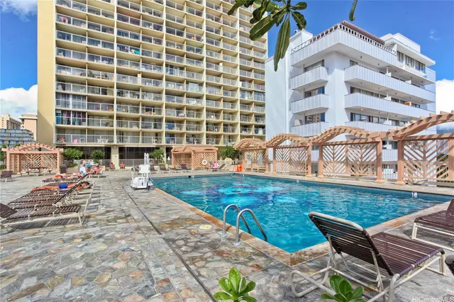 a view of a swimming pool with chairs