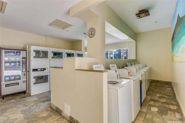 a kitchen with stainless steel appliances granite countertop a refrigerator and a stove