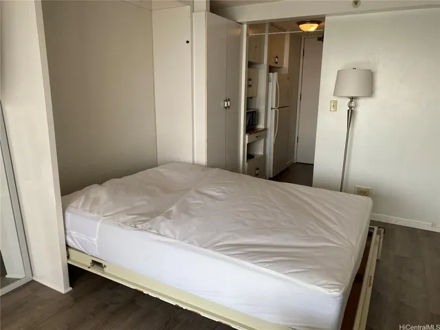 a bedroom with a bed and a lamp