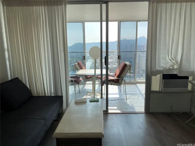 a view of a room with furniture and window