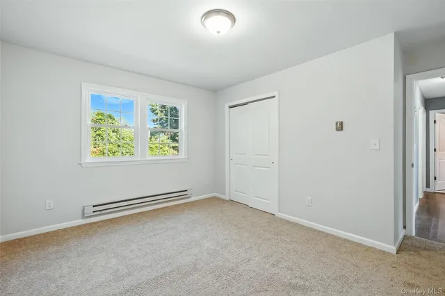 an empty room with windows and closet