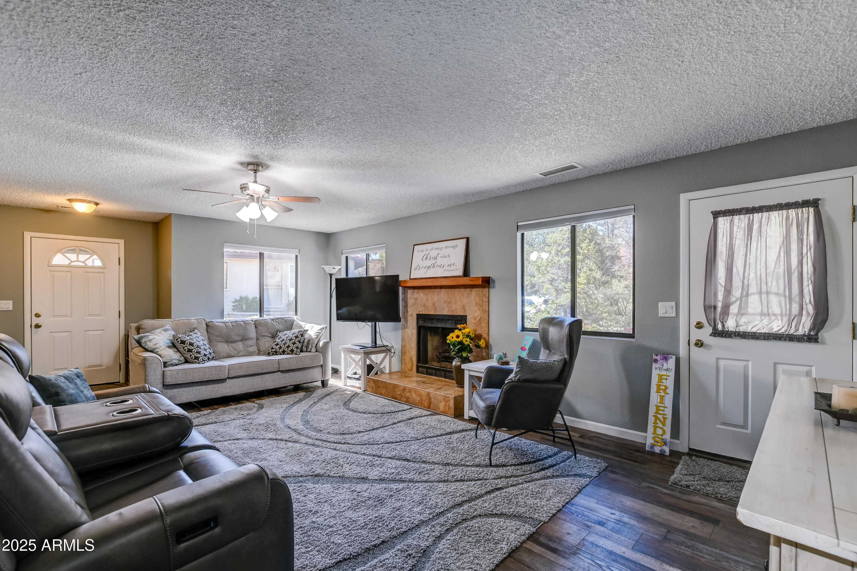 419 Apache Plume Trail Prescott, AZ 86301 - Photo 3 of 21 a living room with furniture and a fireplace