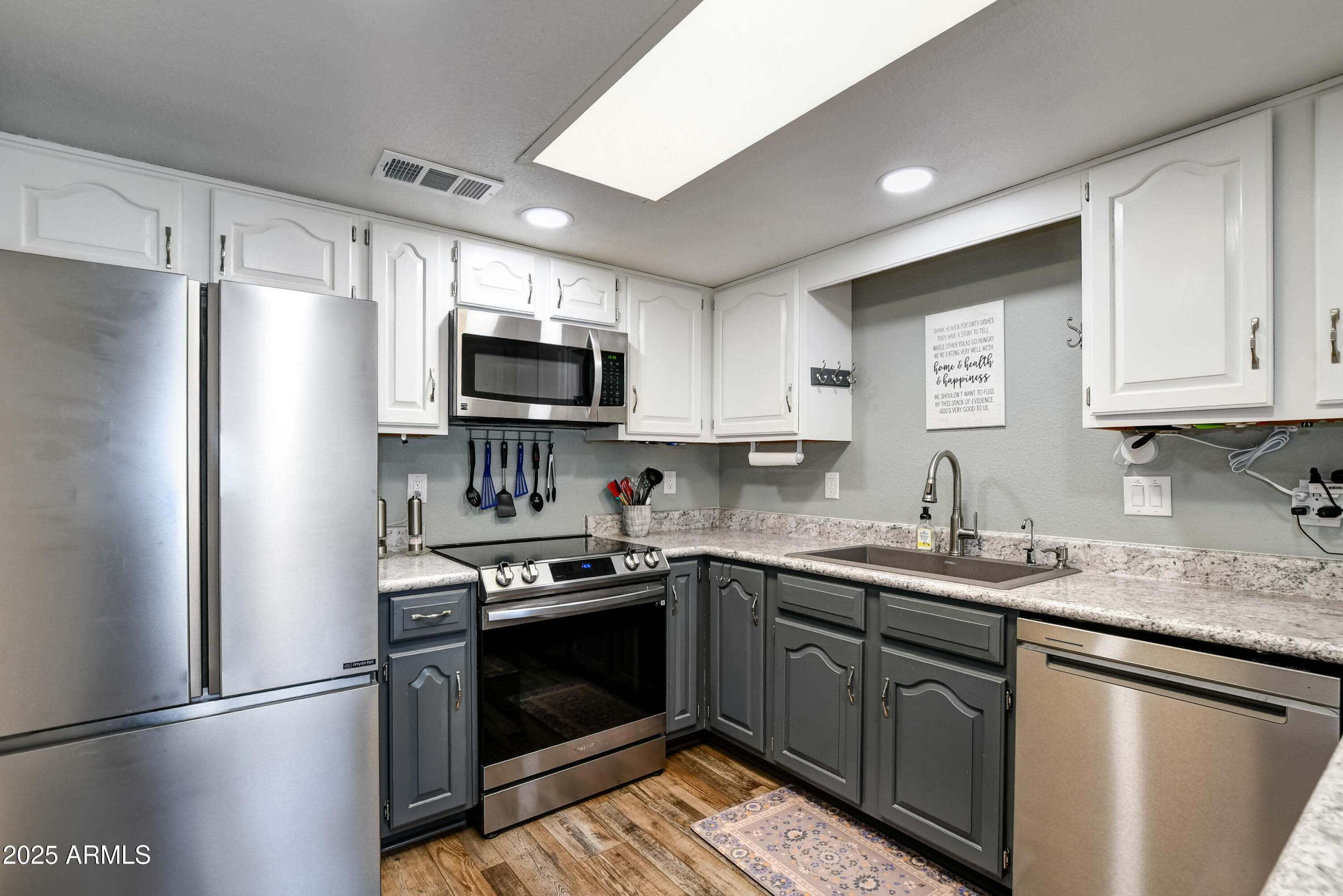 419 Apache Plume Trail Prescott, AZ 86301 - Photo 5 of 21 a kitchen with stainless steel appliances granite countertop a refrigerator stove a sink and a microwave
