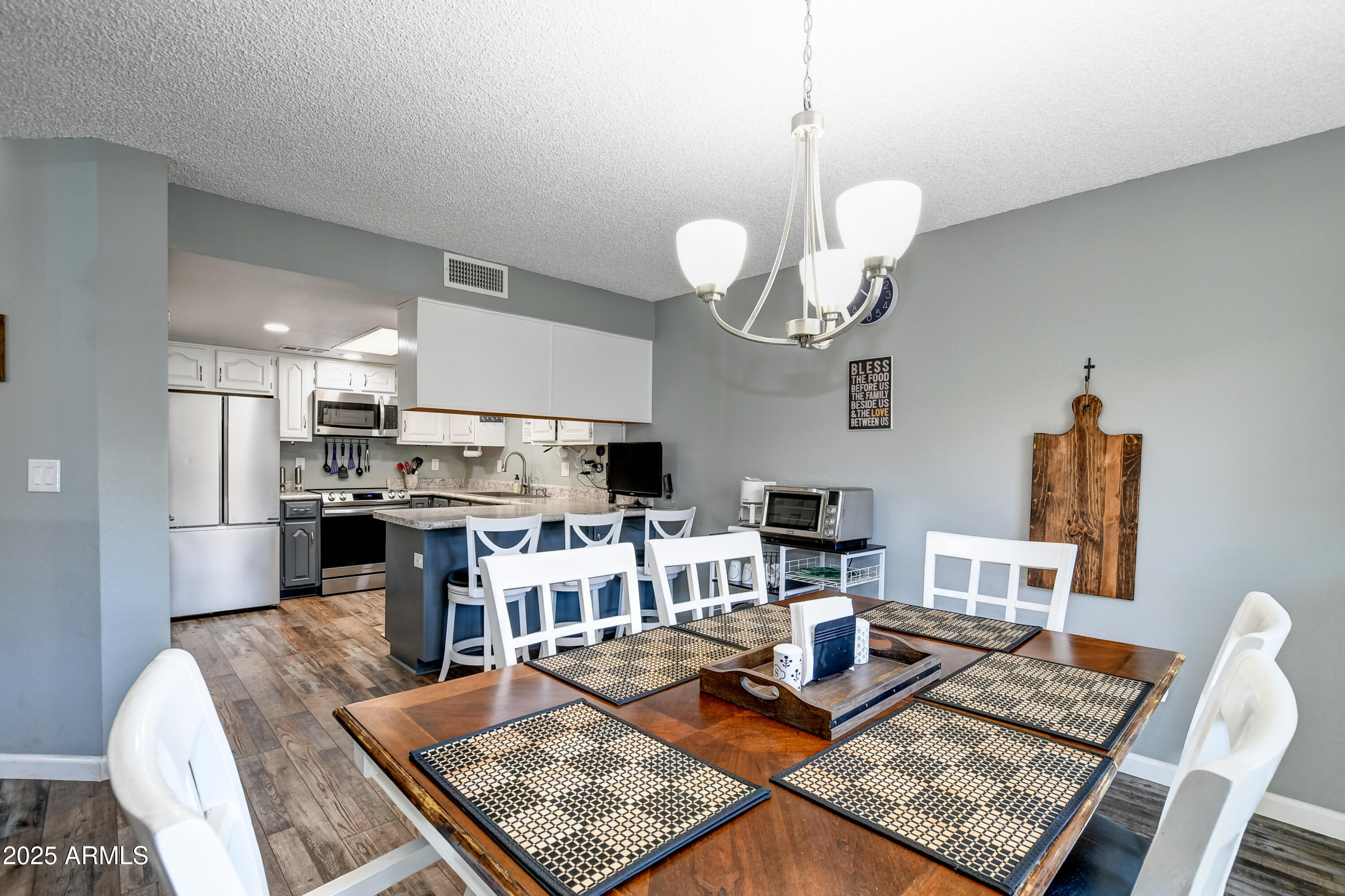 419 Apache Plume Trail Prescott, AZ 86301 - Photo 8 of 21 a living room with kitchen island furniture and a chandelier