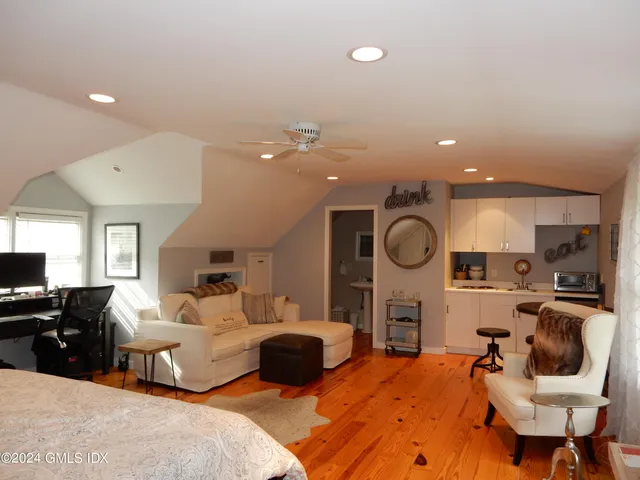 a large bedroom with a bed and glass table