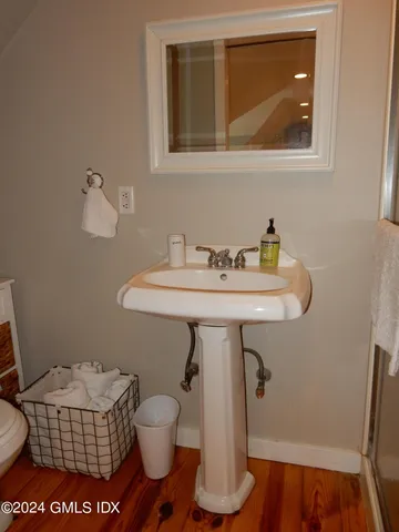 a bathroom with a sink toilet and a mirror