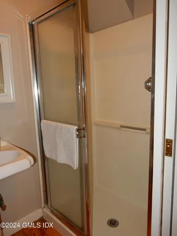 a bathroom with a glass shower door