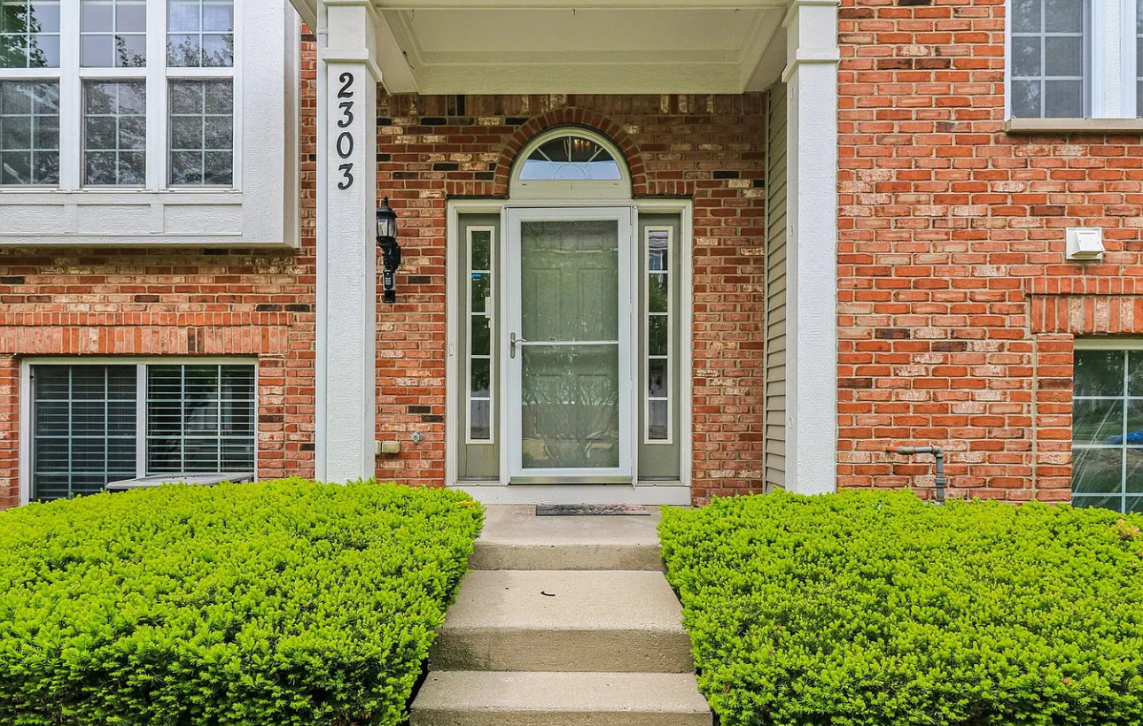 a front view of a house with a garden