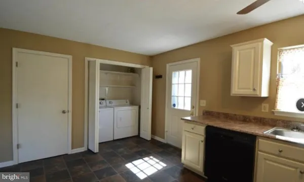 a kitchen with a sink cabinets and a window