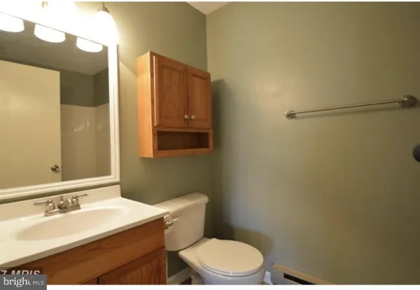 a bathroom with a sink a toilet and mirror