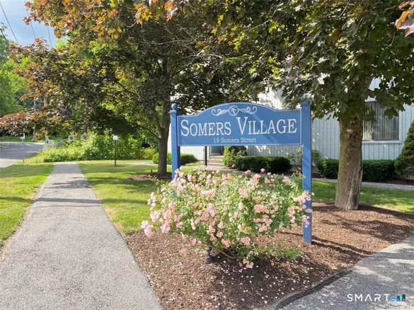 a sign board with yard in front of it