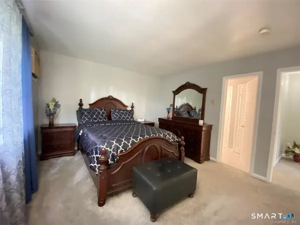 a living room with furniture fireplace and a window