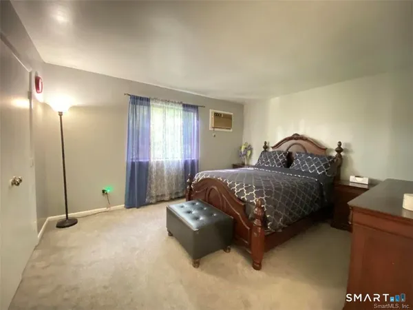 a bedroom with a bed and window