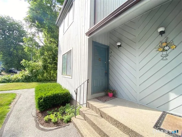 a view of a backyard with plants and a garage