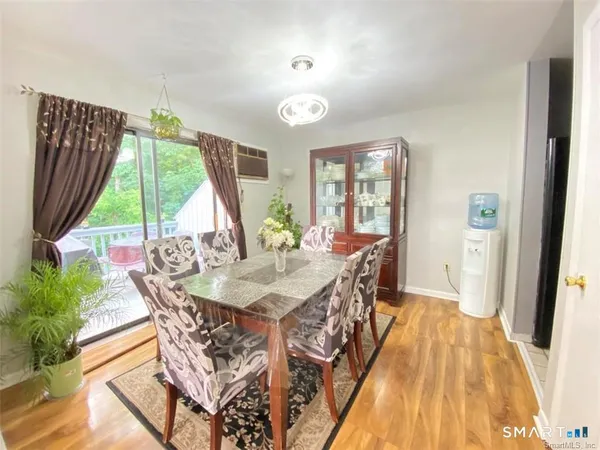 a view of a dining room with furniture window and wooden floor