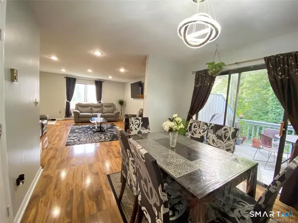 a view of a dining room with furniture wooden floor and chandelier