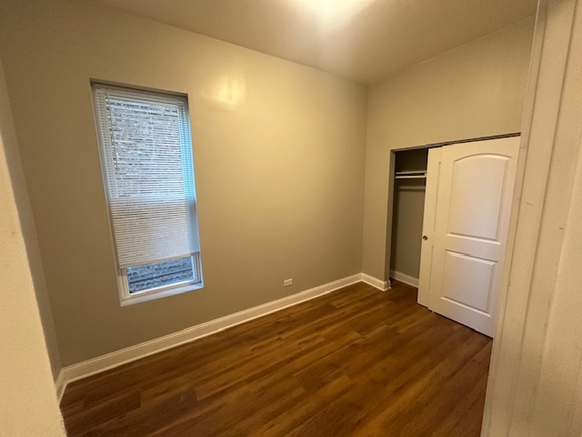 5743 South Emerald Avenue Chicago, IL 60621 - Photo 16 of 28 a view of an empty room with wooden floor