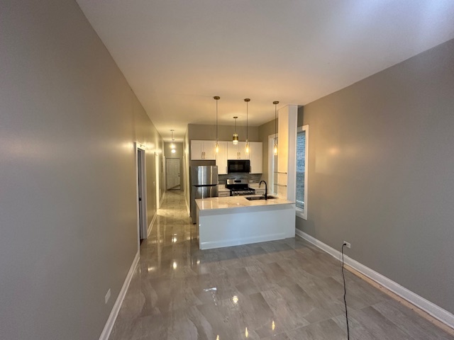 5743 South Emerald Avenue Chicago, IL 60621 - Photo 17 of 28 a view of a kitchen with a sink and cabinets
