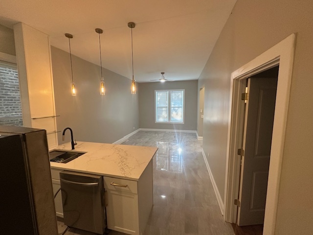 5743 South Emerald Avenue Chicago, IL 60621 - Photo 18 of 28 a kitchen that has a sink a refrigerator a window and a counter top space