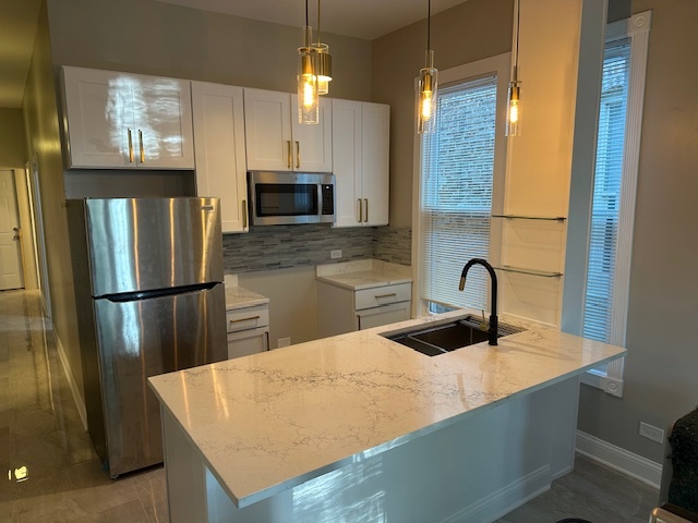 5743 South Emerald Avenue Chicago, IL 60621 - Photo 2 of 28 a kitchen with stainless steel appliances a refrigerator a sink a stove and cabinets