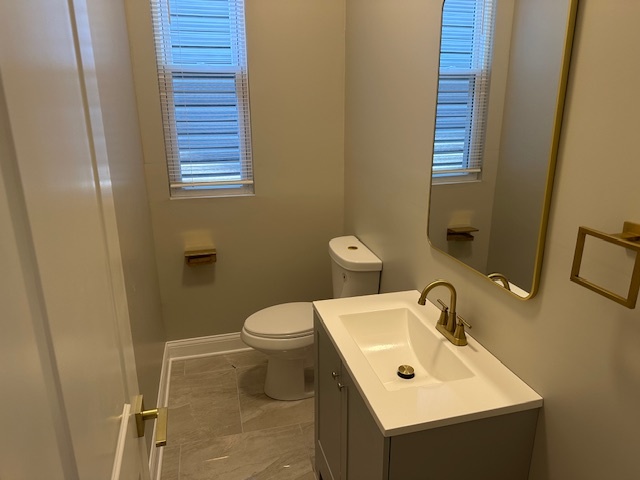 5743 South Emerald Avenue Chicago, IL 60621 - Photo 7 of 28 a bathroom with a sink mirror and toilet