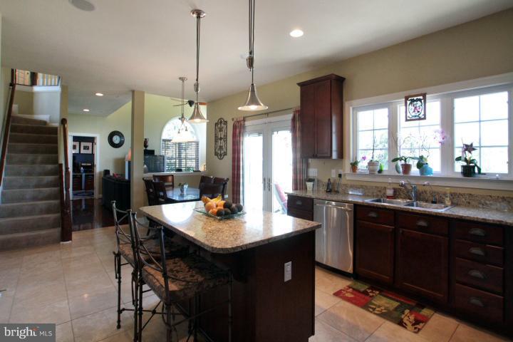 19505 Middletown Road Freeland, MD 21053 - Photo 10 of 30 a kitchen with a sink a counter space dining table and chairs