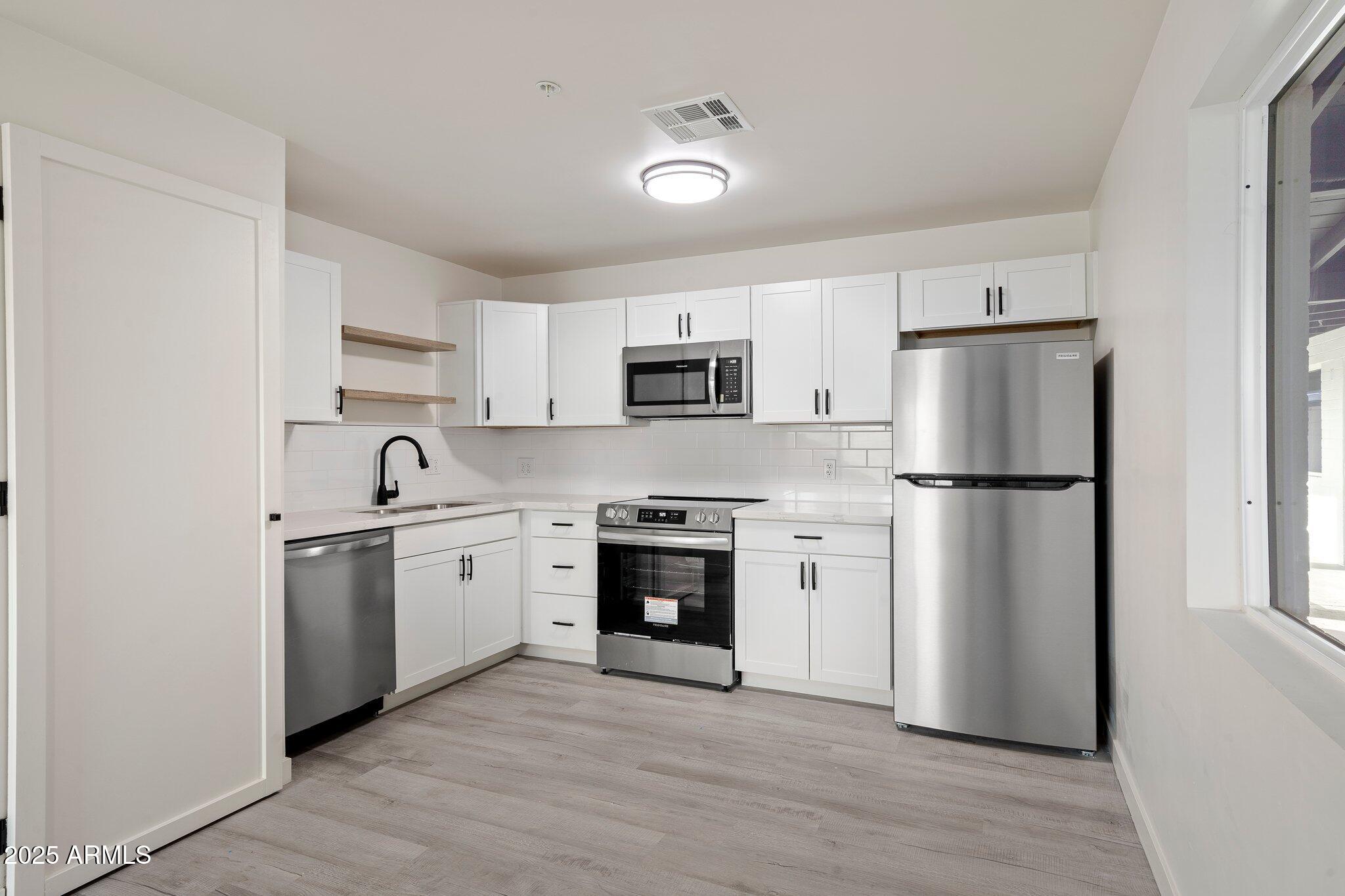 3114 North 68th Street, Unit 4 Scottsdale, AZ 85251 - Photo 12 of 25 a kitchen with a refrigerator stove and sink