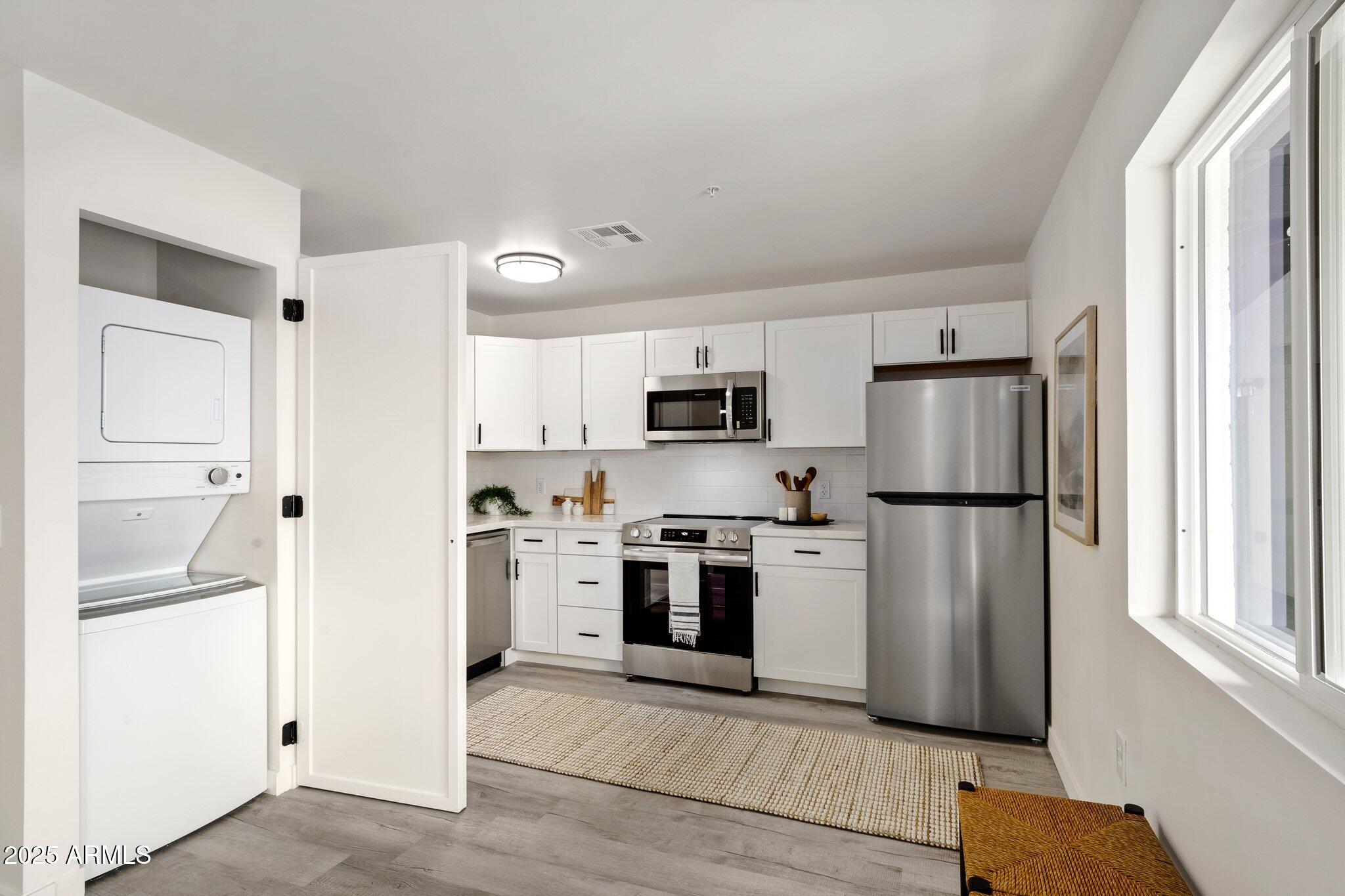 3114 North 68th Street, Unit 4 Scottsdale, AZ 85251 - Photo 2 of 25 a kitchen with stainless steel appliances a refrigerator sink and microwave