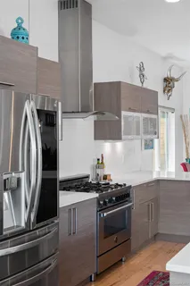a living room with furniture large window and a flat screen tv