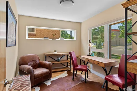 a view of balcony with furniture and wooden floor
