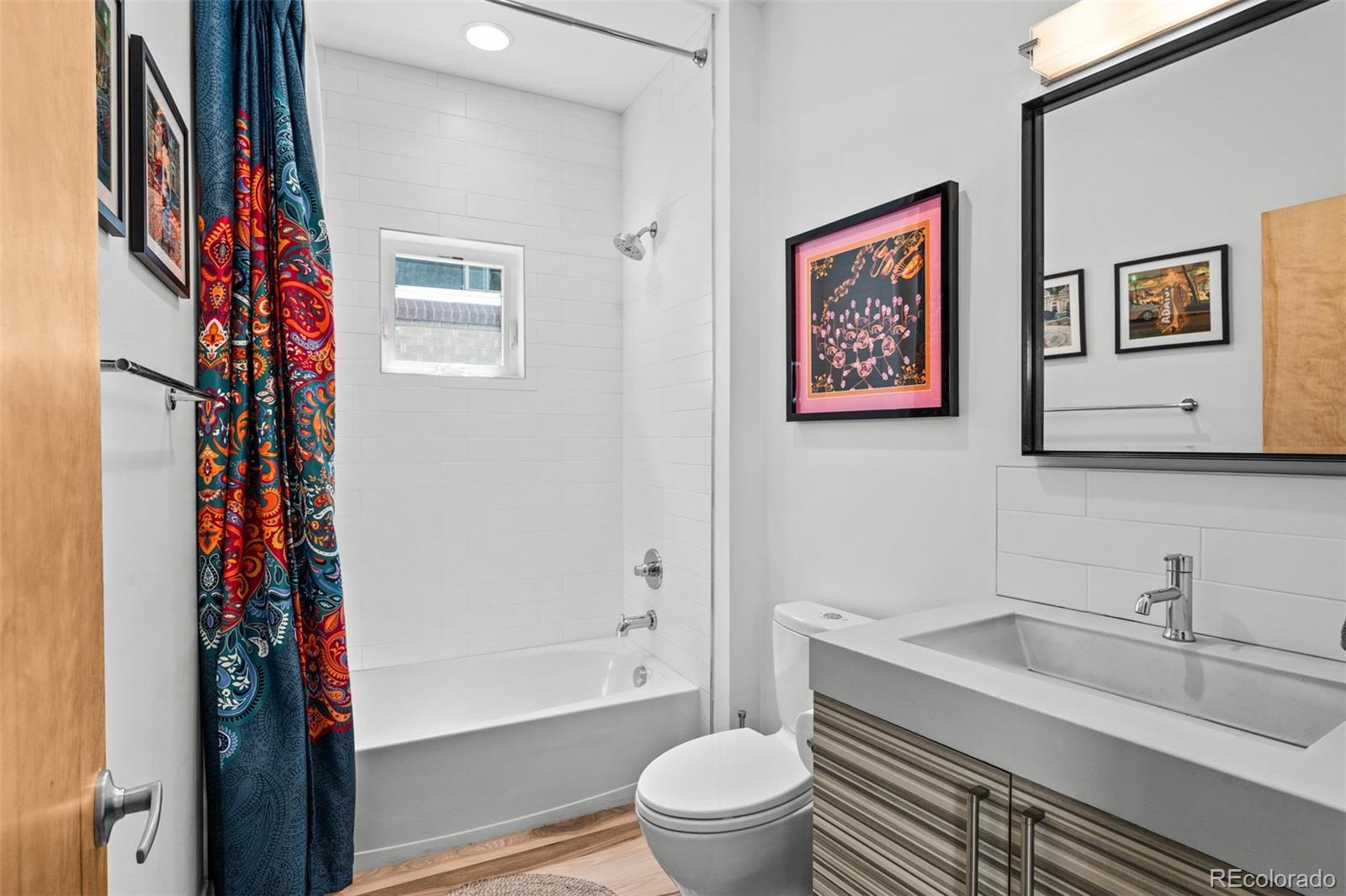 3632 North Pecos Street Denver, CO 80211 - Photo 20 of 47 a bathroom with a granite countertop sink toilet and a bathtub