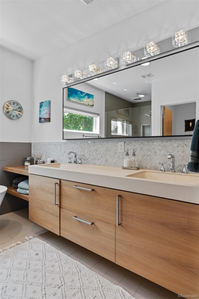 3632 North Pecos Street Denver, CO 80211 - Photo 26 of 47 a spacious bathroom with double sink and a mirror