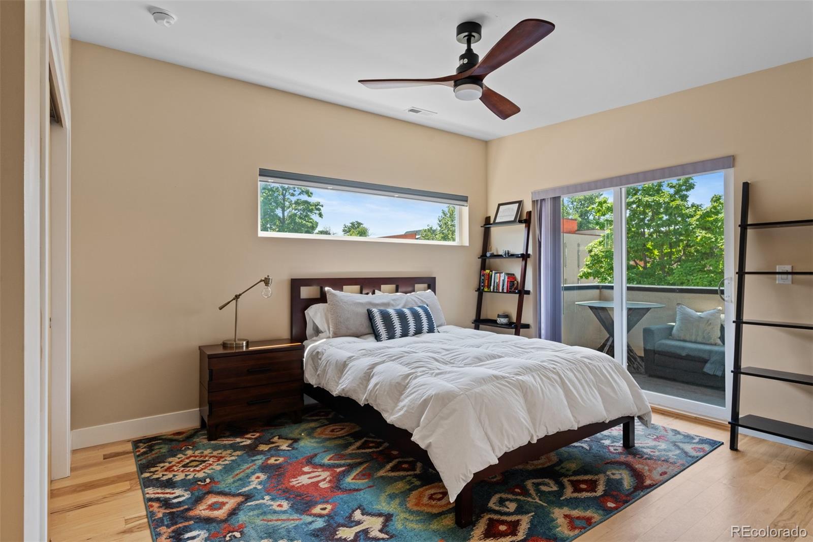 3632 North Pecos Street Denver, CO 80211 - Photo 29 of 47 a bedroom with a bed a dresser and a large window