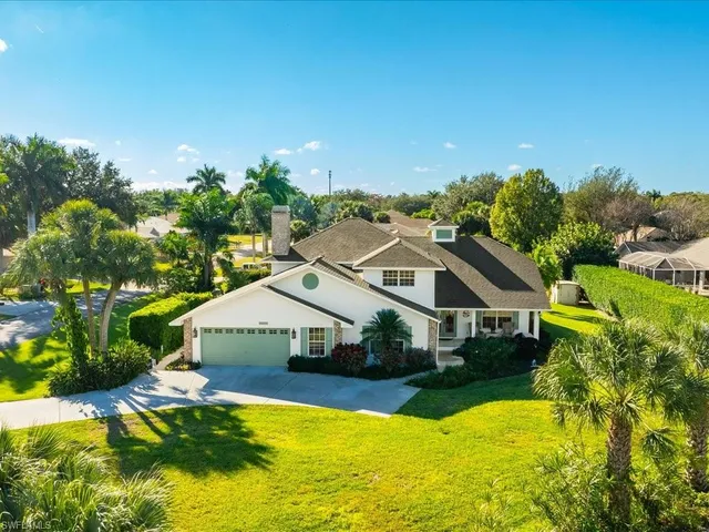 a view of a house with swimming pool and a yard