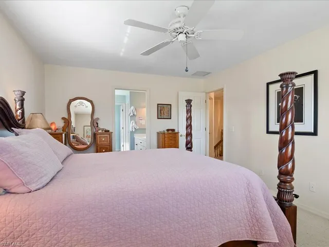 a bedroom with a bed and dresser with mirror