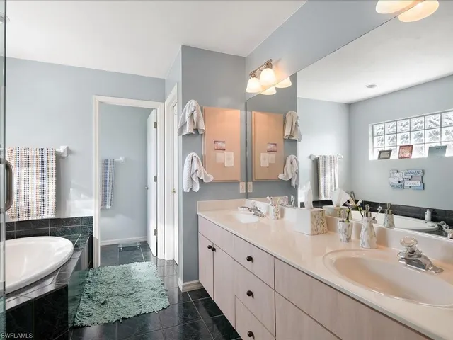 a spacious bathroom with a double vanity sink mirror and double