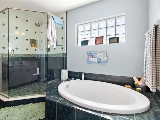 a bathroom with a bathtub and a shower