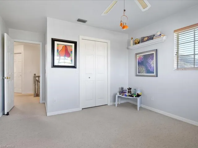 a hallway with cabinet and stairs