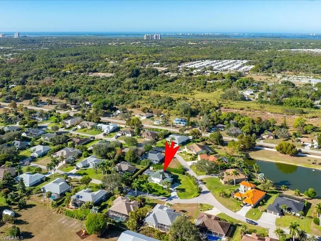 an aerial view of residential building and lake